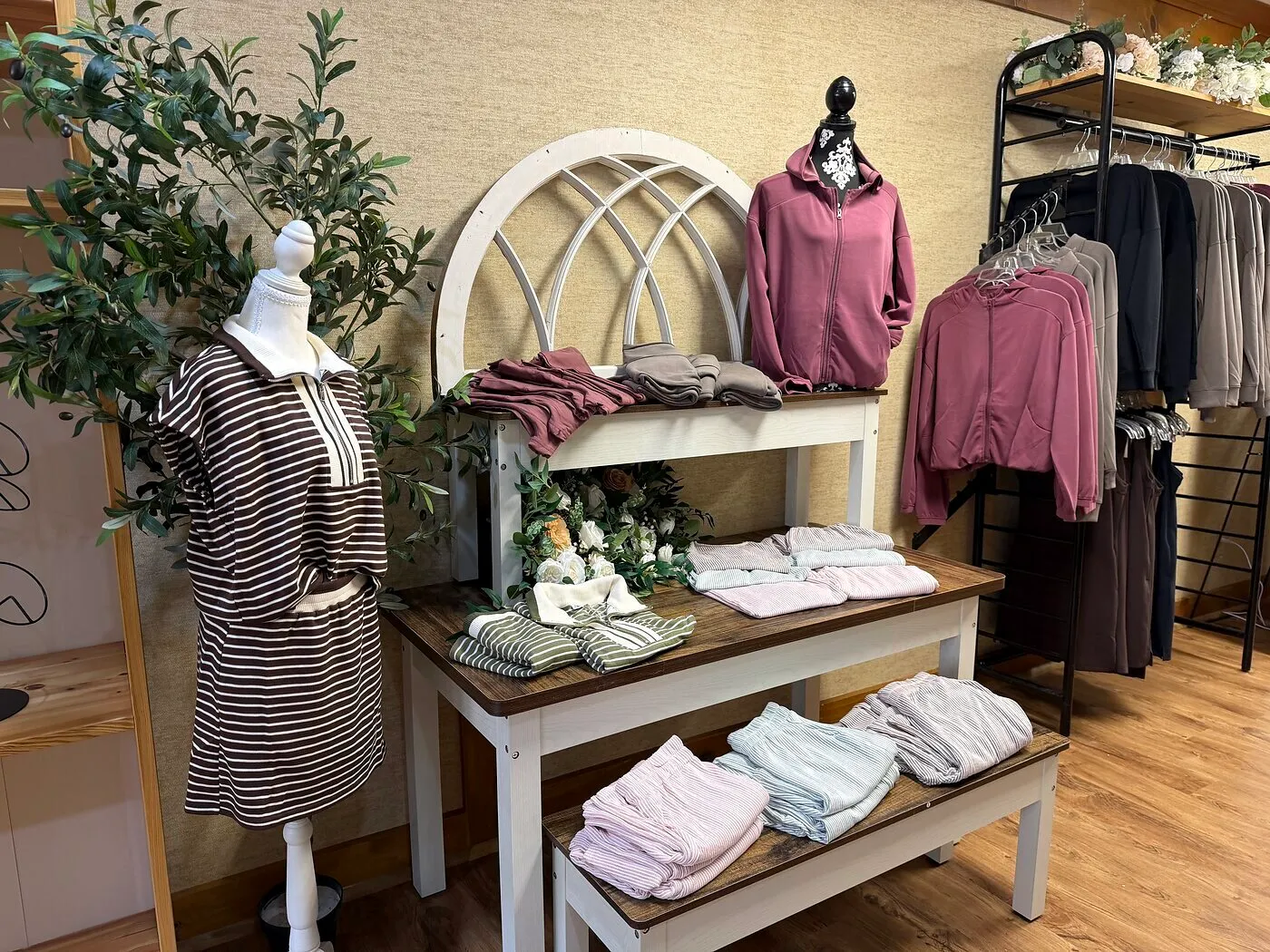 The front display at Serenity: folded loungewear, zip hoodies and the arched window frame