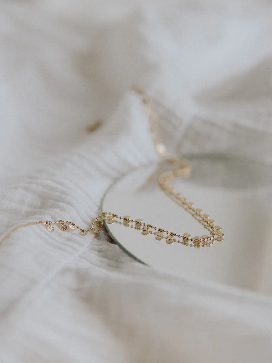 A fine gold necklace on white linen