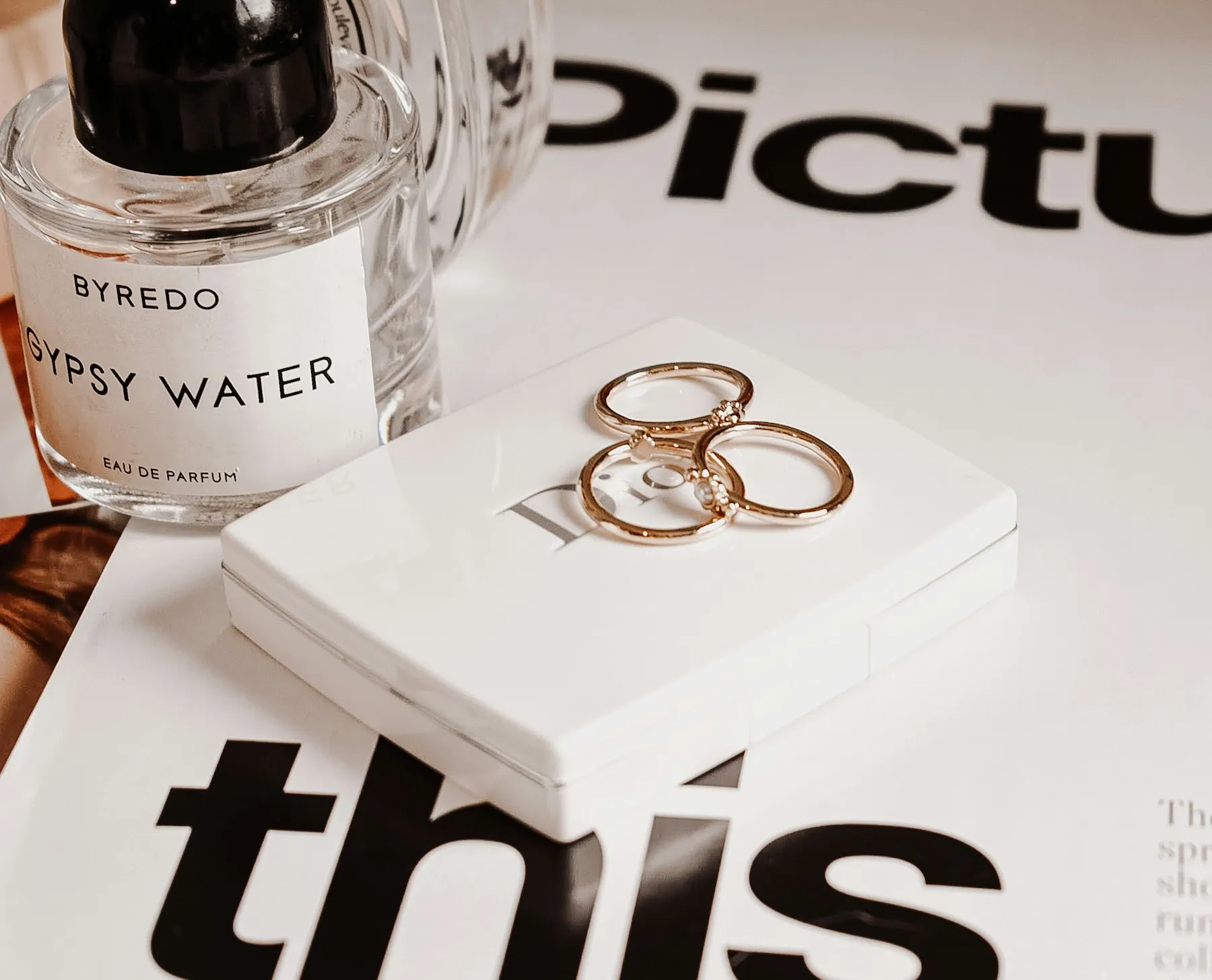 Gold and silver rings arranged on a pale surface