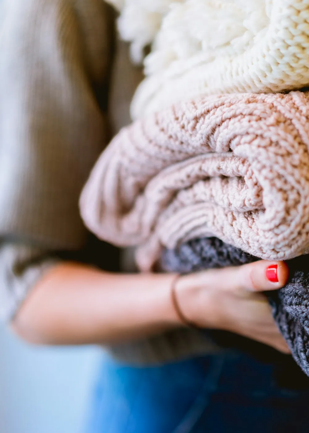 Hands holding folded knitted textiles