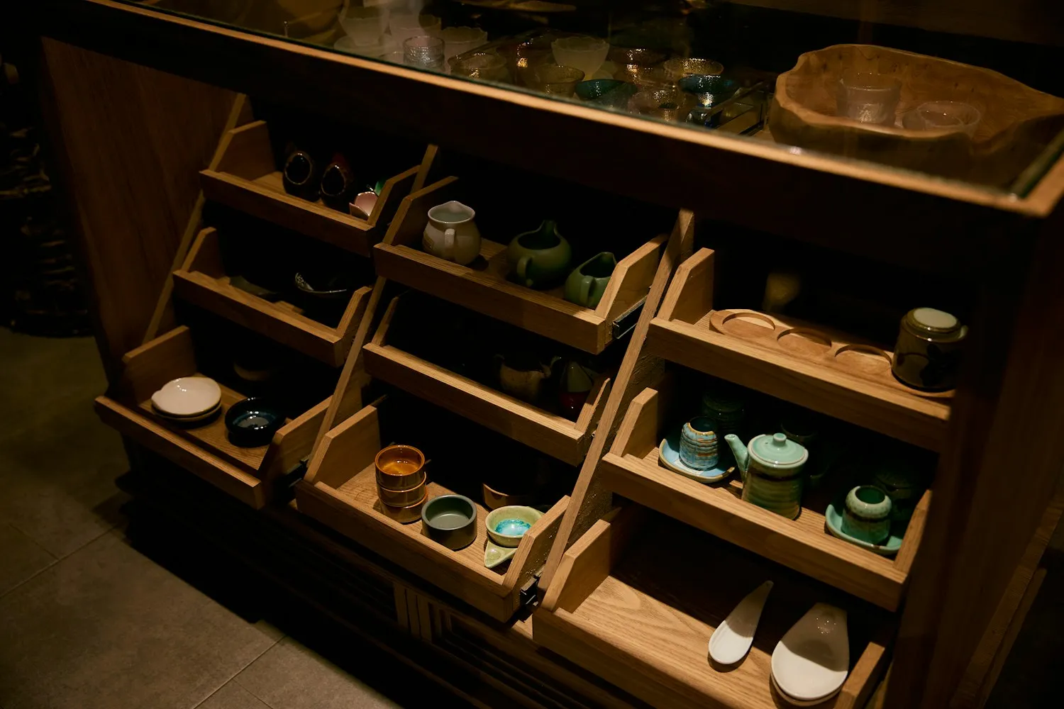 Wooden shelves holding ceramics and small goods